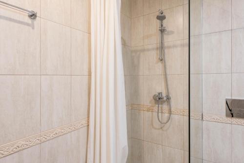 a bathroom with a shower with a shower curtain at Seaside Apartment in Varna City
