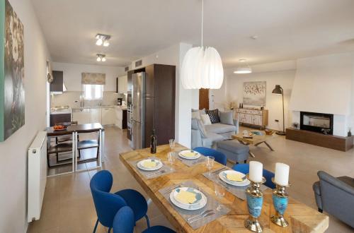 a kitchen and living room with a table and chairs at Holiday Maisonette in Varkiza by GHH in Vari