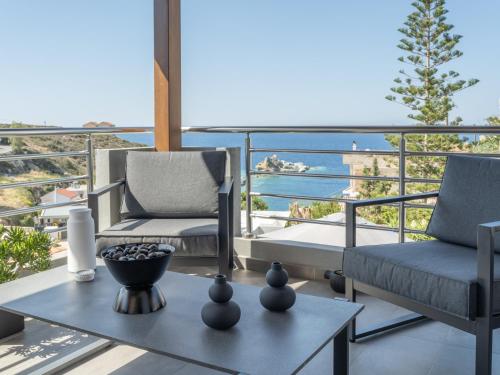 a balcony with two chairs and a table with a view at D&A View Luxury Villa 60meters from the Sea in Lygaria