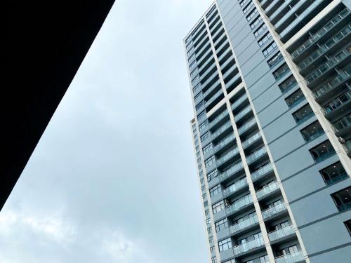 a tall apartment building with the sky in the background at Good and Modern 2BR Daan Mogot City Apartment By Travelio in Jakarta