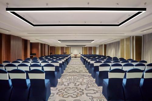 a conference room with blue and white chairs in it at Doubletree By Hilton Bengaluru Whitefield in Bengaluru