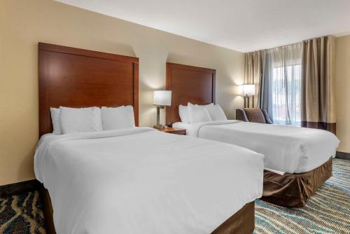 a hotel room with two beds and a window at Comfort Inn Asheville East-Blue Ridge Pkwy Access in Asheville