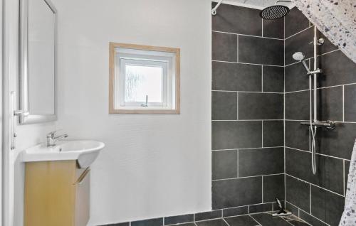 a bathroom with a sink and a shower at Nice Home In Løkken With Kitchen in Løkken