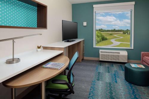 an office with a desk and a computer and a window at Home2 Suites By Hilton Lake Mary Orlando in Lake Mary
