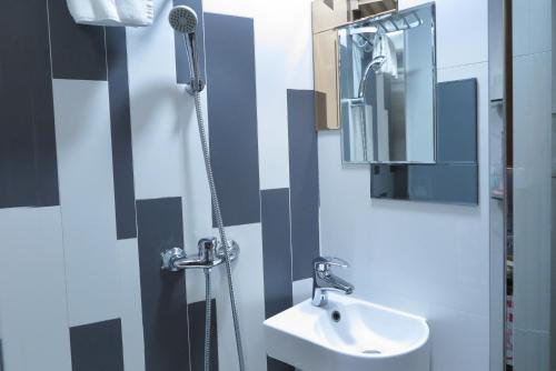 a bathroom with a shower and a sink and a mirror at Shanghai Red in Hong Kong