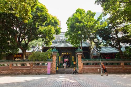 a building in a park with people walking around it at Shanghai Red in Hong Kong