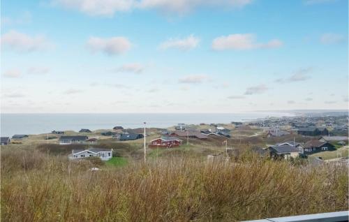 a view of a town with houses and the ocean at Holiday Home Klitbakkevej in Lønstrup