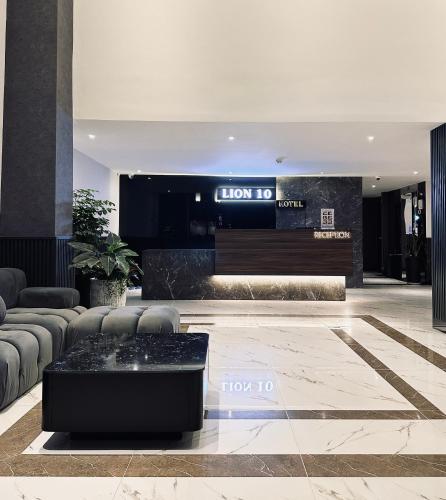 a lobby with a couch and a table at LION 10 HOTEL in Can Tho
