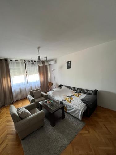 a living room with a bed and a couch at Devetka in Pirot