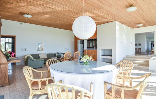 a dining room with a table and chairs at Awesome Home In Holstebro With Kitchen in Holstebro