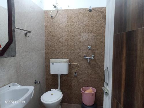 a bathroom with a toilet and a sink at Hotel Ambassador Inn in Gwalior