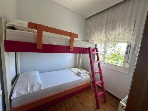 a bunk bed with a ladder in a room at ADA's Guest House in Gjirokastër