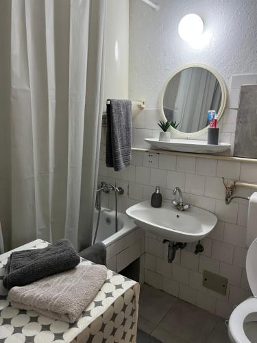 a bathroom with a sink and a toilet and a mirror at Devetka in Pirot