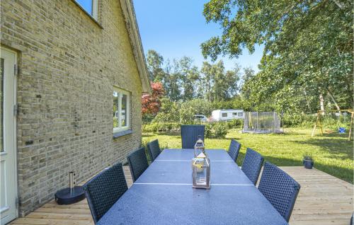 a blue table and chairs on a patio at Beautiful Home In Rønde With Kitchen in Rønde