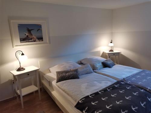 a bedroom with a bed with blue sheets and pillows at "Meer" Urlaub in Ostholstein in Oldenburg in Holstein