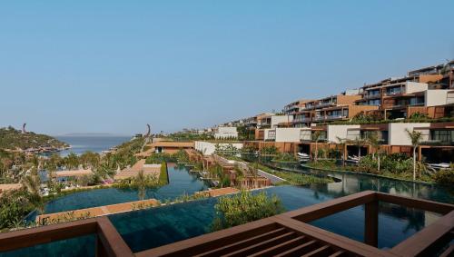 arial view of a resort with a river and buildings at Maxx Royal Bodrum in Bodrum City