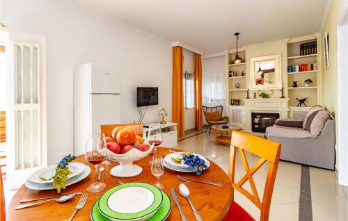 a living room with a table with a bowl of fruit at Nice Home In Velez - Malaga With Wifi in Vélez-Málaga