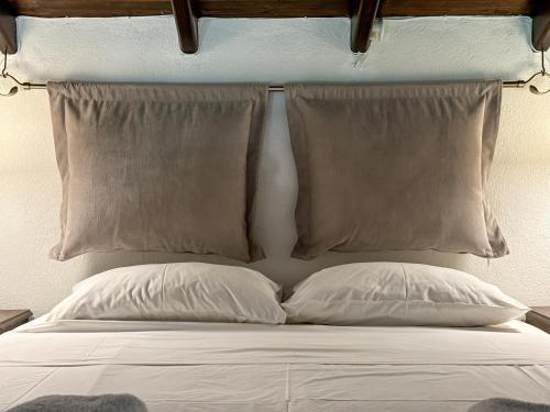 a bed with two pillows and a head board at Kedros in Neokhórion