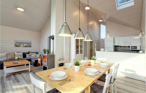 a dining room and living room with a table and chairs at Amazing Home In Krems Iiwarderbrück in Göls
