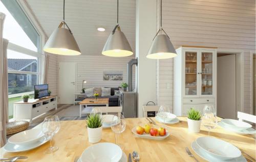 a dining room with a table with plates and glasses at Amazing Home In Krems Iiwarderbrück in Göls