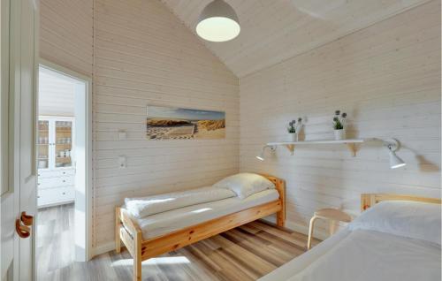 a bedroom with two beds and a window at Amazing Home In Krems Iiwarderbrück in Göls