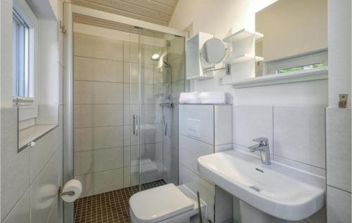 a bathroom with a toilet and a sink and a shower at Amazing Home In Krems Iiwarderbrück in Göls
