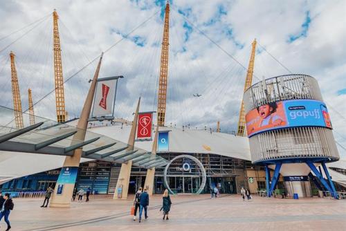 a group of people walking in front of a stadium at Greenwich-02 in London