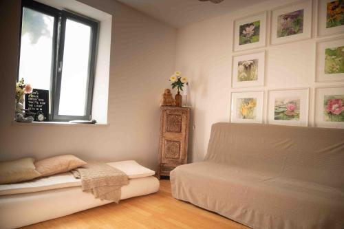 a bedroom with a white bed and a window at Wellness Rental Vienna in Vienna