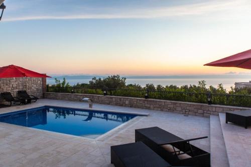 a swimming pool with a view of the ocean at Ferienhaus in Veliko Brdo mit Eigenem Balkon und Meerblick in Veliko Brdo