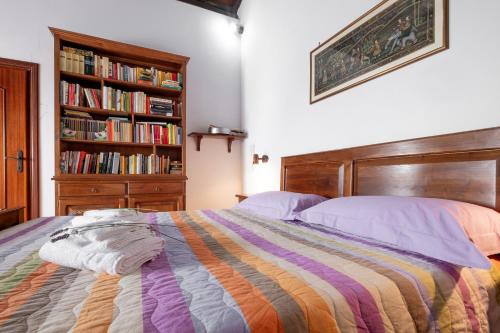 a bedroom with a bed and a book shelf with books at Casaletto della musica in Viterbo