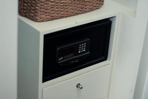 a microwave oven in a white kitchen cabinet at Casablanca Suites Near Airport in Legazpi