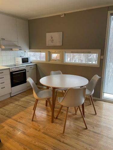 a kitchen with a table and chairs in a room at SamiCity Hotel As in Karasjok