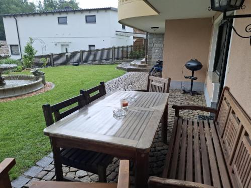 a wooden table and chairs on a patio at Wohnung Ländliche Lage in Wald
