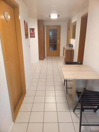 a hallway with a table and chairs in a room at Wohnung Ländliche Lage in Wald