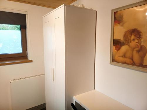 a white cabinet in a room next to a window at Wohnung Ländliche Lage in Wald
