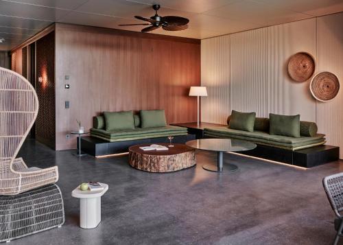 a living room with two couches and a table at Maxx Royal Bodrum in Bodrum City