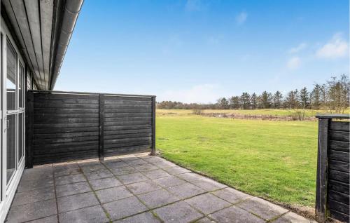 a gate on the side of a house with a field at Lovely Home In Pandrup With Kitchen in Pandrup