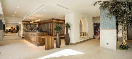 a lobby of a store with a counter at Ilunion Caleta Park in Sant Feliu de Guixols