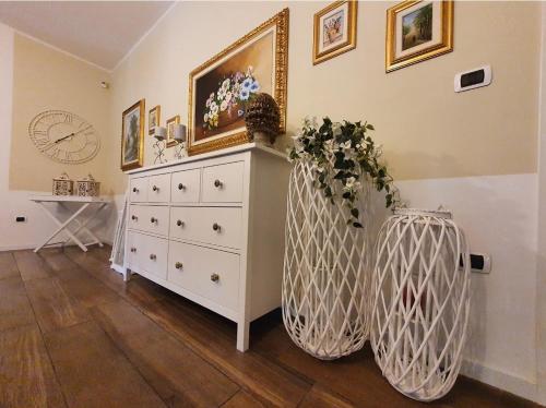 a room with a white dresser with flowers on it at Tenuta viale degli ulivi in San Martino in Pensilis