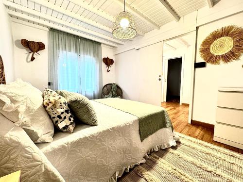 a bedroom with a bed and a large window at As Carolinas in Isla de Arosa