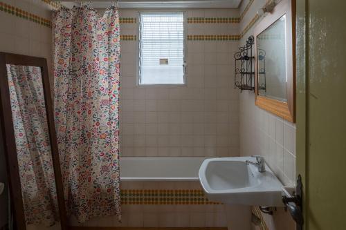 a bathroom with a shower curtain and a sink at House -Sleeps 8-Natural Pool-Pet Friendly in Artana