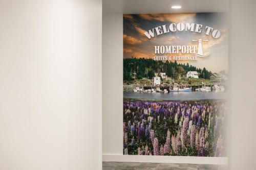 a wall with a poster in a room with purple flowers at Homeport Suites & Residences in Lords Cove 