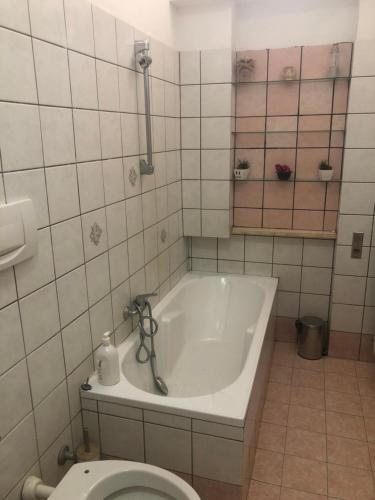 a bathroom with a tub and a toilet at Casa Nonna Rosa in Nettuno