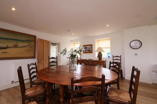 a dining room with a wooden table and chairs at Salton Lodge Spacious Country Stay in Salton