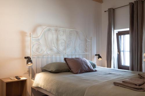 a bed with a white headboard in a bedroom at Relax Home Funtana in Funtana