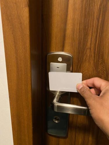 a person unlocking a door with a cell phone at Hôtel Le Saint Amand in Saint-Amand-Montrond