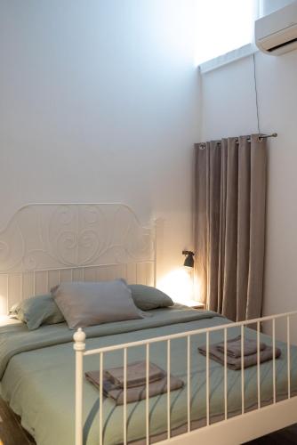 a bedroom with a white bed and a curtain at Relax Home Funtana in Funtana