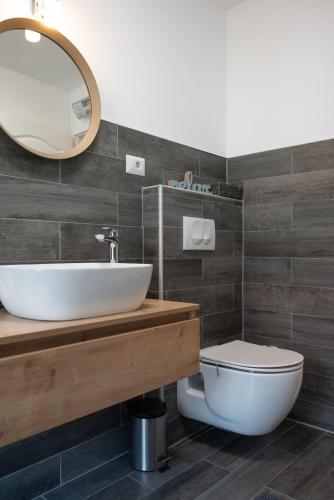 a bathroom with a sink and a toilet at Relax Home Funtana in Funtana