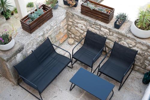 a group of chairs and a table on a patio at Relax Home Funtana in Funtana