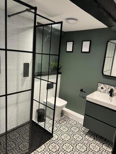 a bathroom with a shower and a toilet and a sink at The Loft in Carnforth